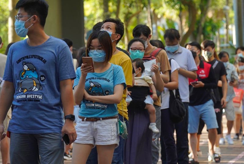 People queue up to vote in Hong Kong Sunday, July 12, 2020, in an unofficial primary for pro-democracy candidates ahead of legislative elections in September. (Photo by Vincent Yu/AP Photo)